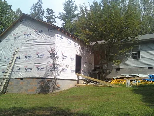 Tyvek wrapped gable on a new room addition beside an existing home in Cheshire